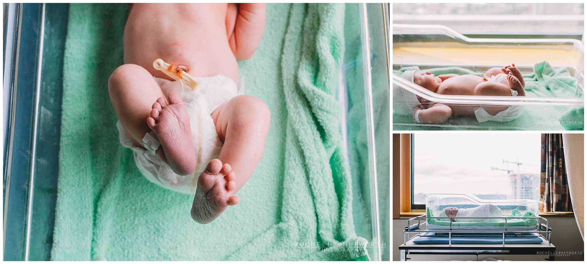 photo showing legs of newborn baby in hospital crib with green blanket