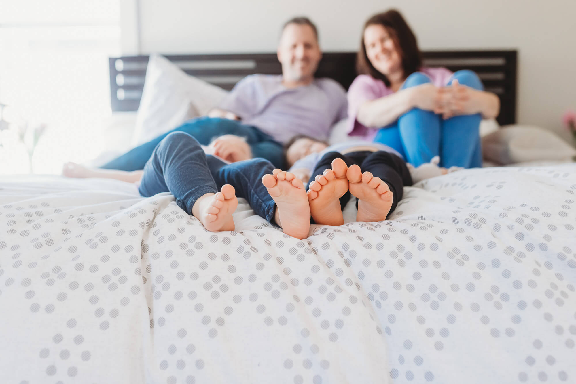 lifestyle photos of kids feet with parents looking on