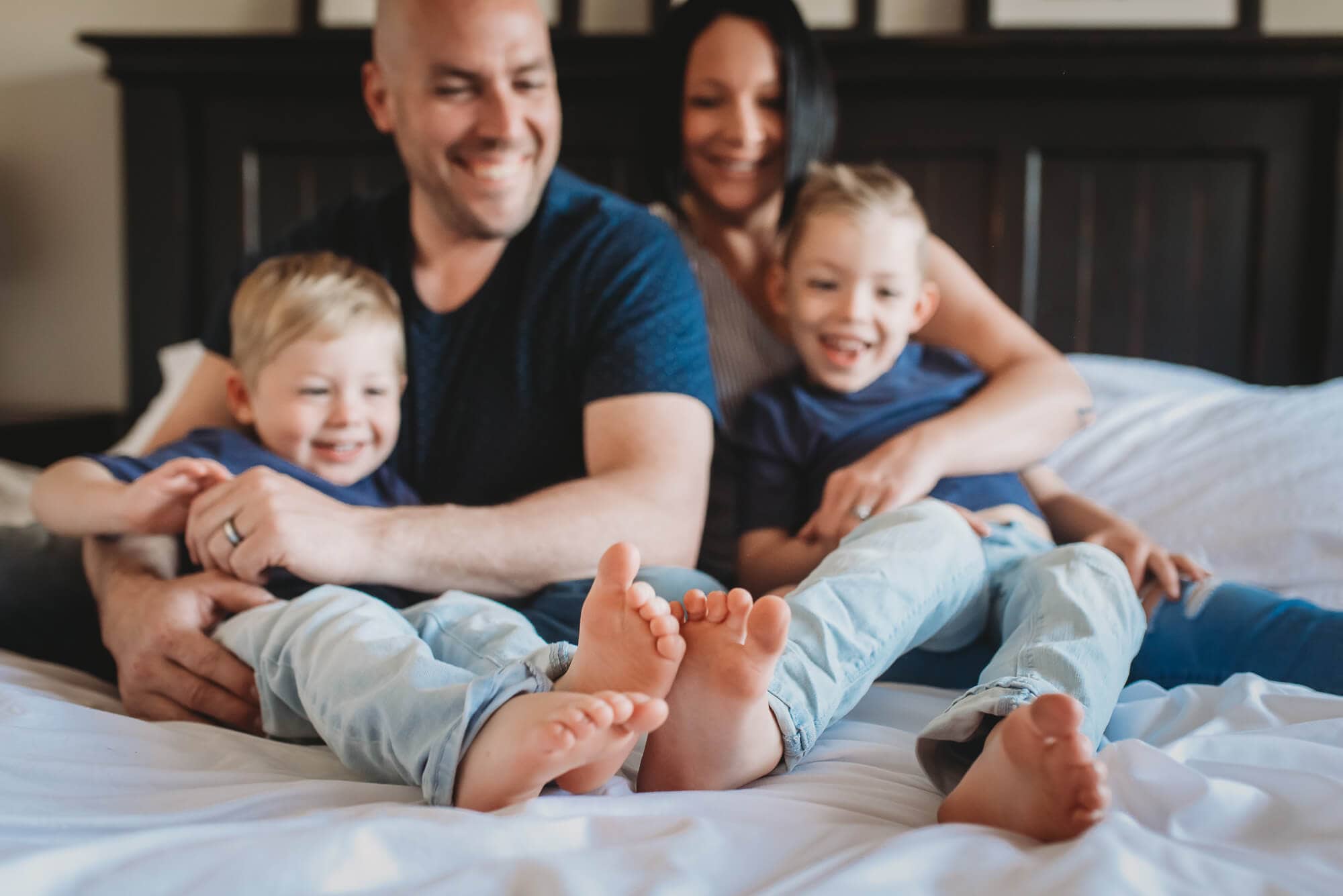 family on bed in family photography session