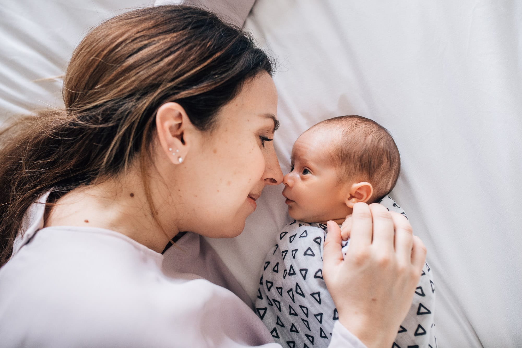 mom and newborn baby lie nose to nose for vancouver newborn photos