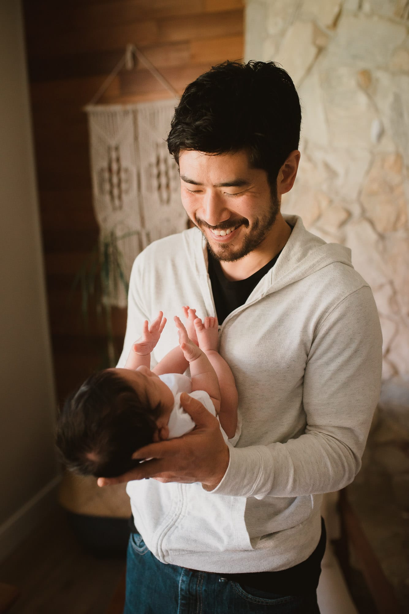 port coquitlam newborn photographer captures dad smiling at newborn baby
