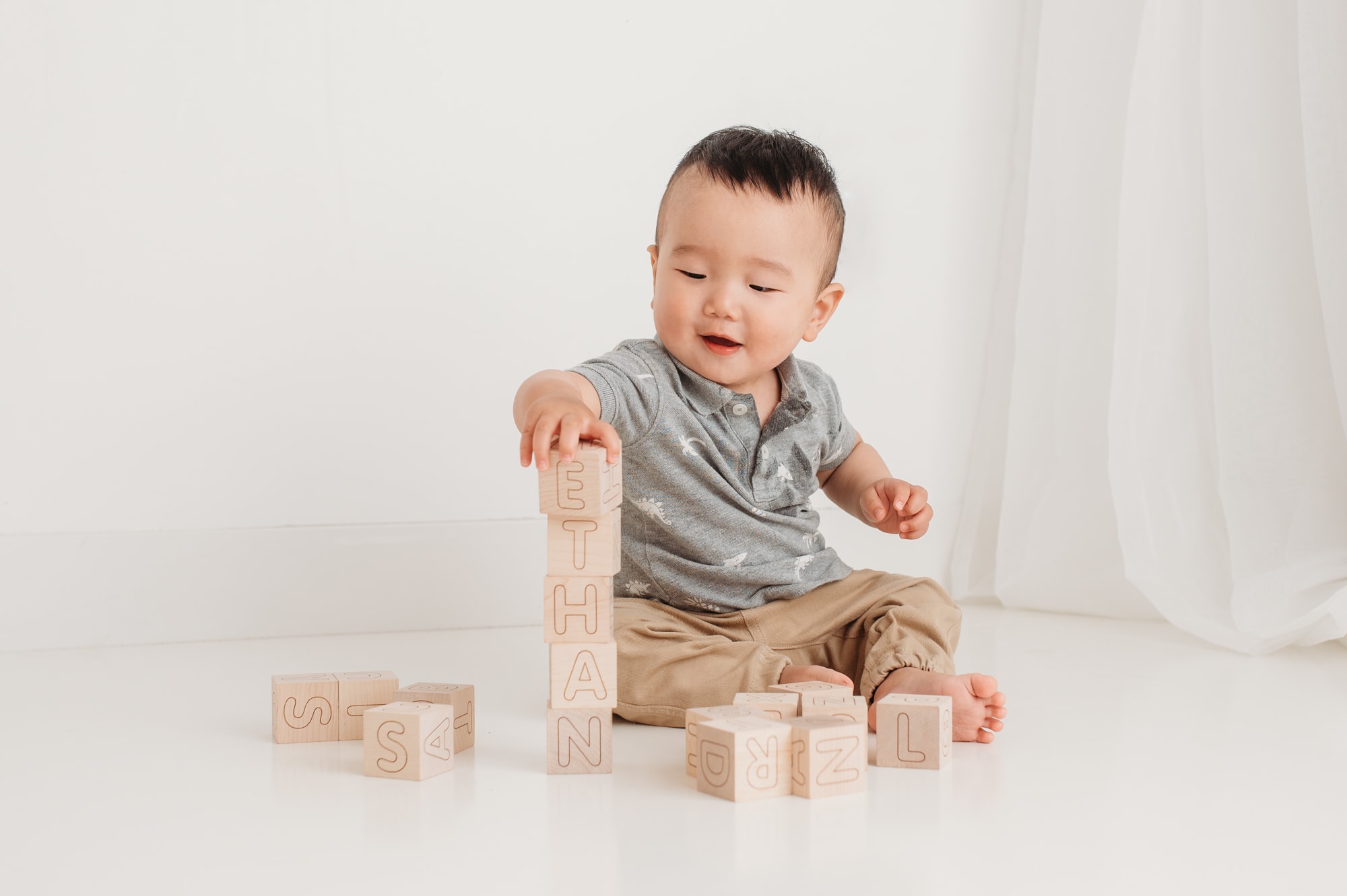 Big baby session with child spelling his name in blocks.