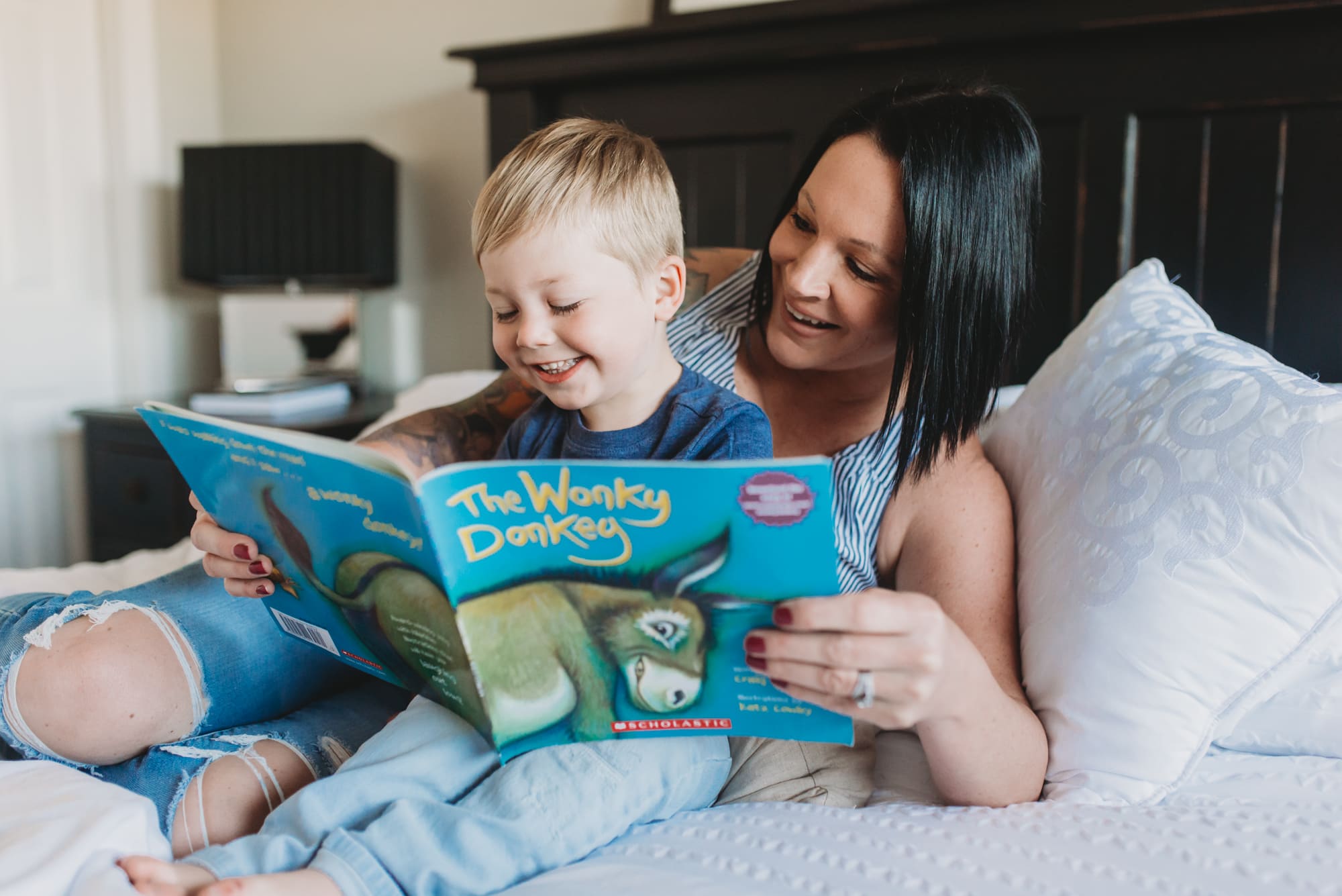 Vancouver Family Photographer shows mom and toddler reading book during Vancouver family photo session