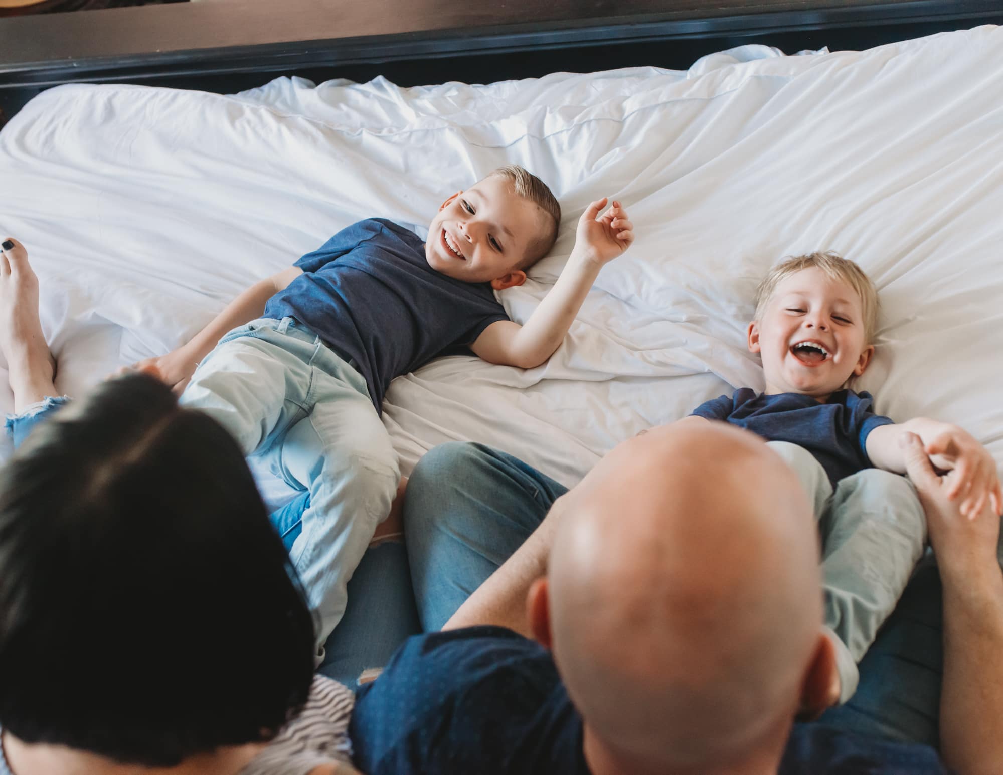 Vancouver family photographer session with two boys laughing on bed