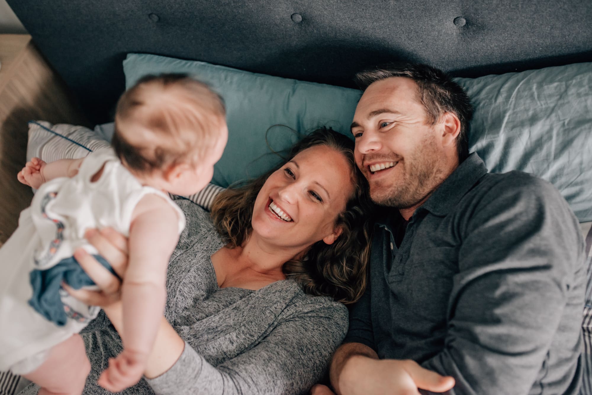 couple laughing with daughter captured by Vancouver Family Photographer