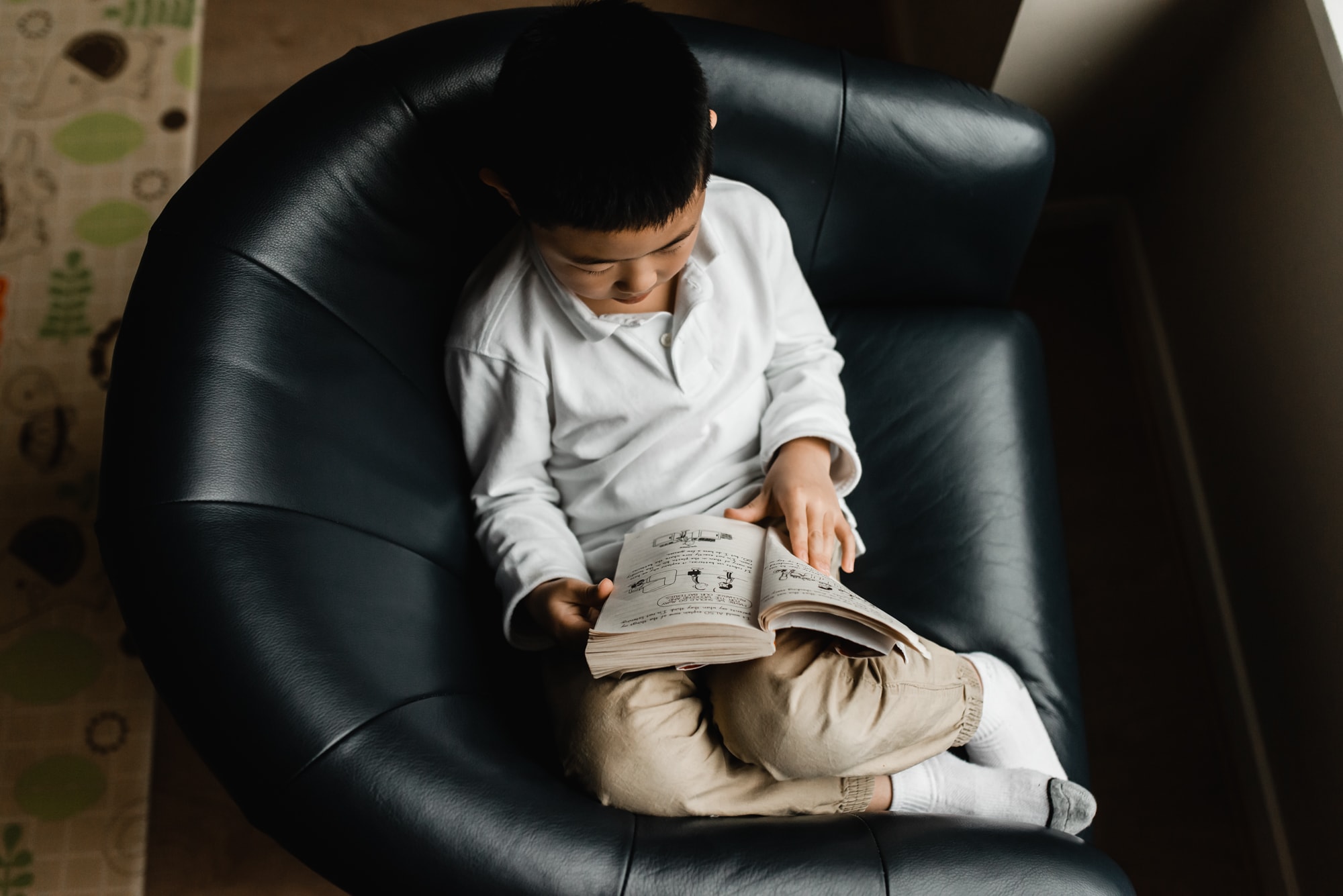 boy reading in chair in Burnaby family photo session
