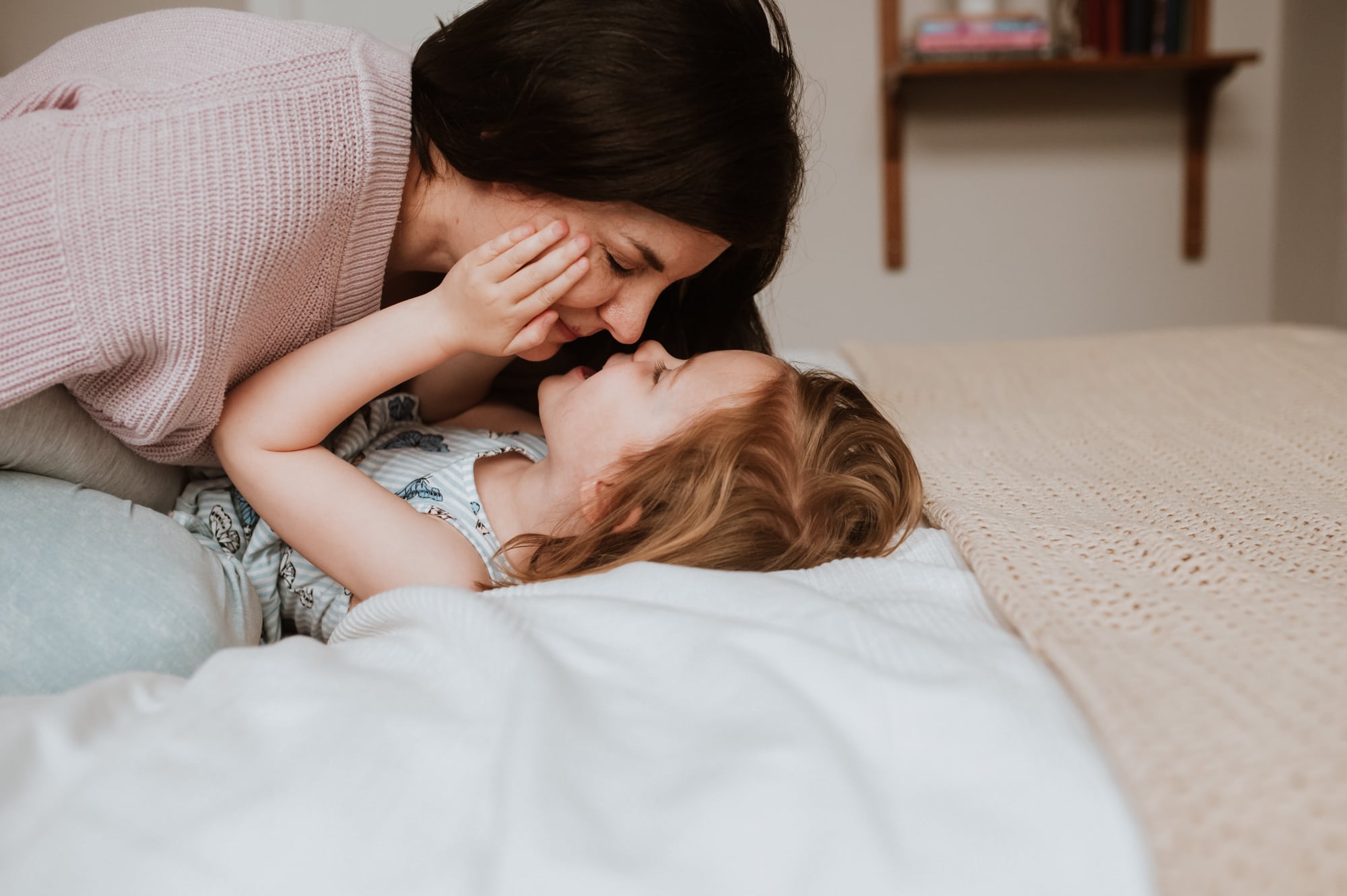Vancouver indoor family session shows mom and daughter tenderly rubbing noses