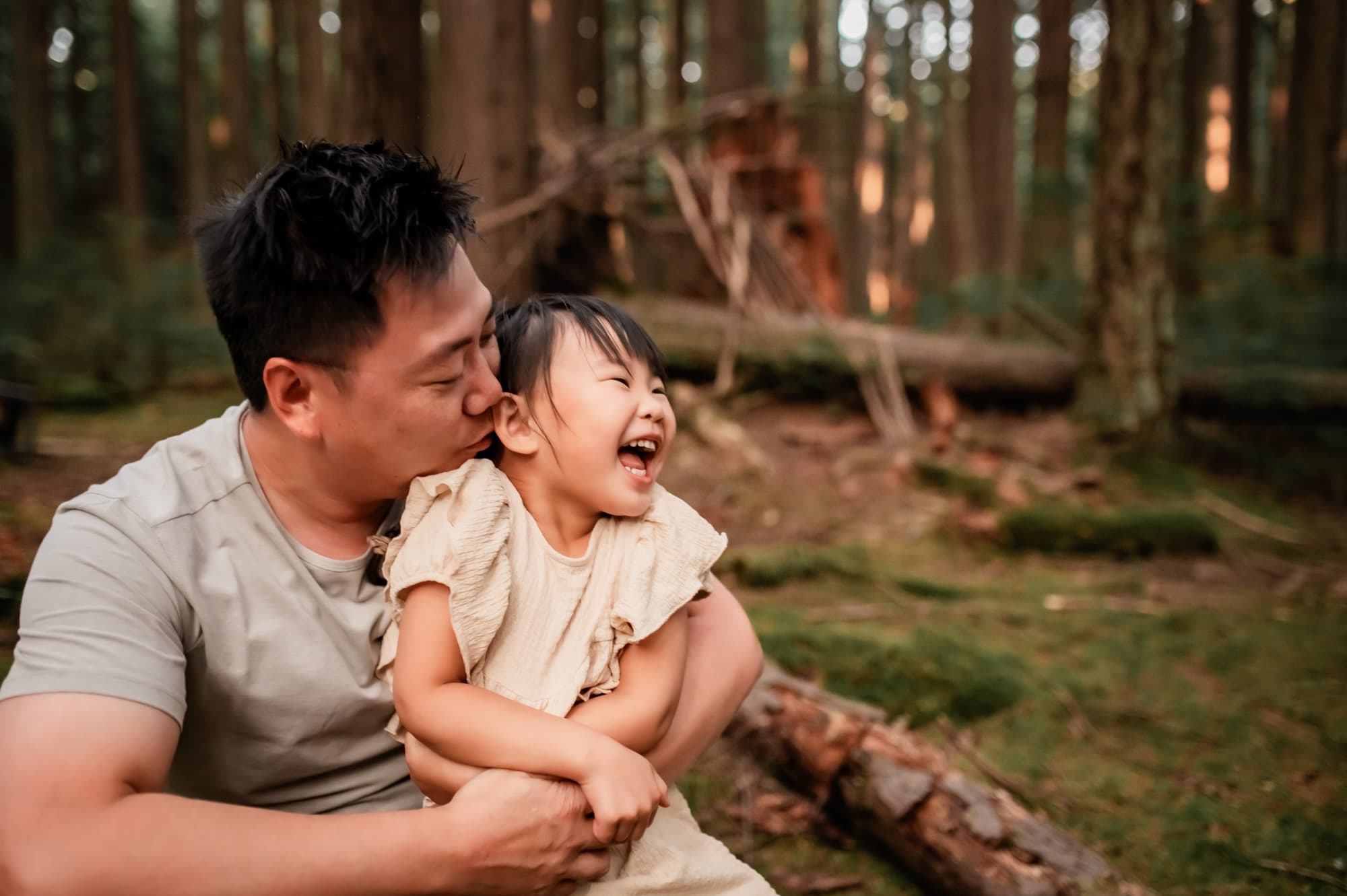 Dad and daughter laughing in the Pacific Spirit Park family photo session.