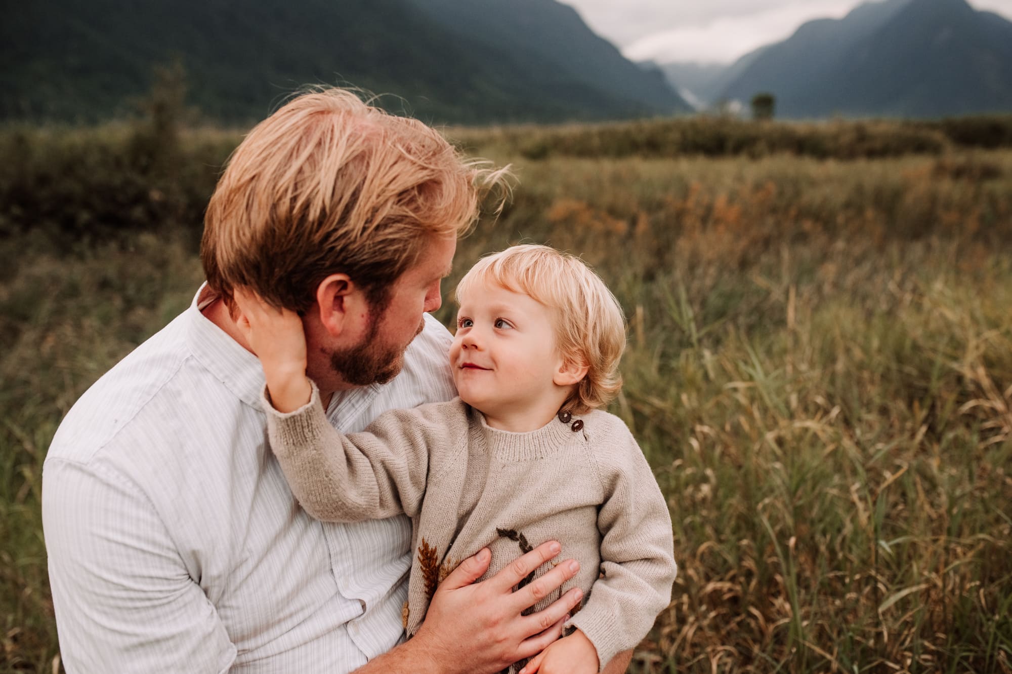 Boy gently cups his dad's face in Maple Ridge photo session.