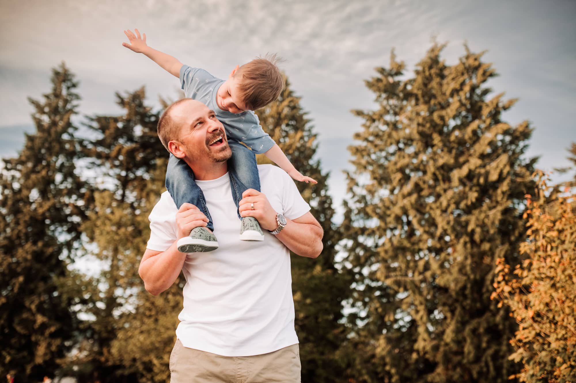 West Vancouver photographer captures cute moment of boy playing airplane on his dad's shoulders.