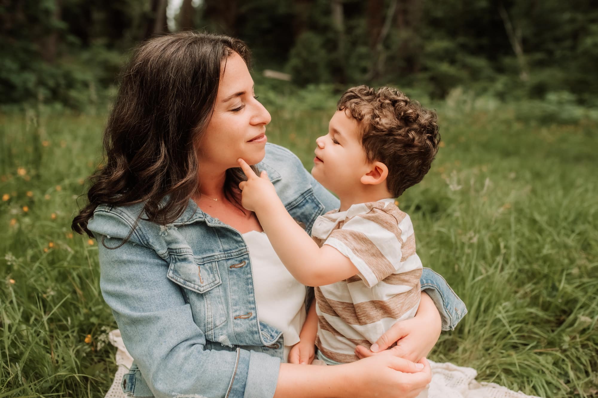 Vancouver family photographer captures a tender moment between mom and toddler son, with him softly touching her cheek.